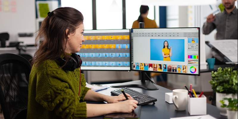 Banner image 3 showing a graphic designer working on a digital illustration with a drawing tablet and design software